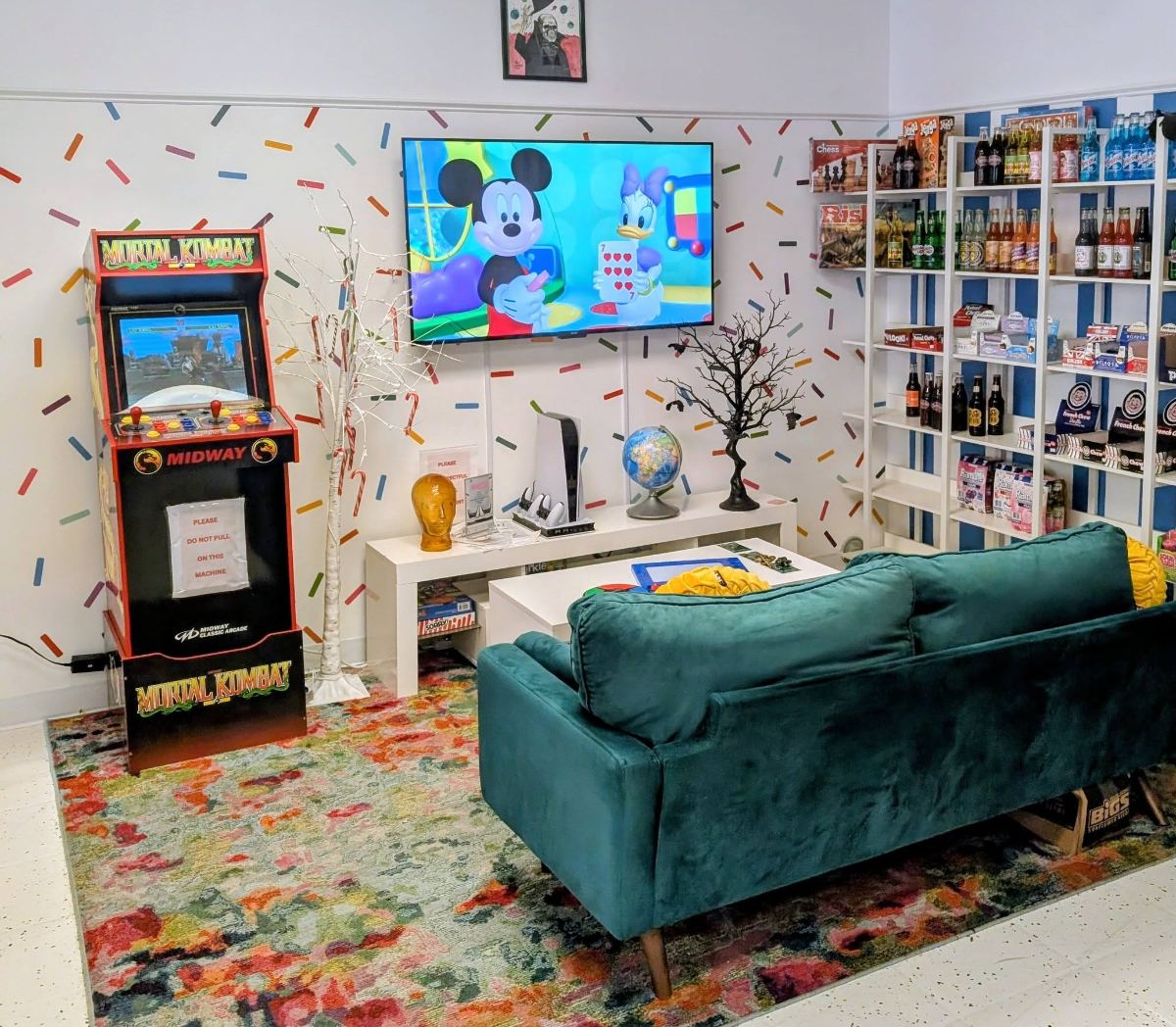 The lounge at Jawbreakers with an arcade machine, couch and board games